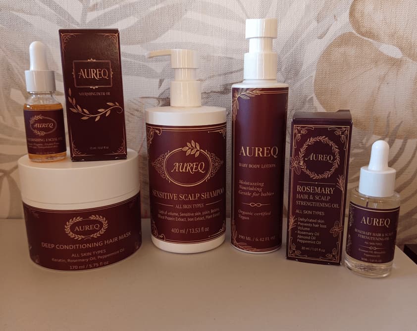 Aureq skincare and hair care products on a neutral background